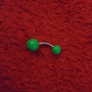 Green belly button piercing
